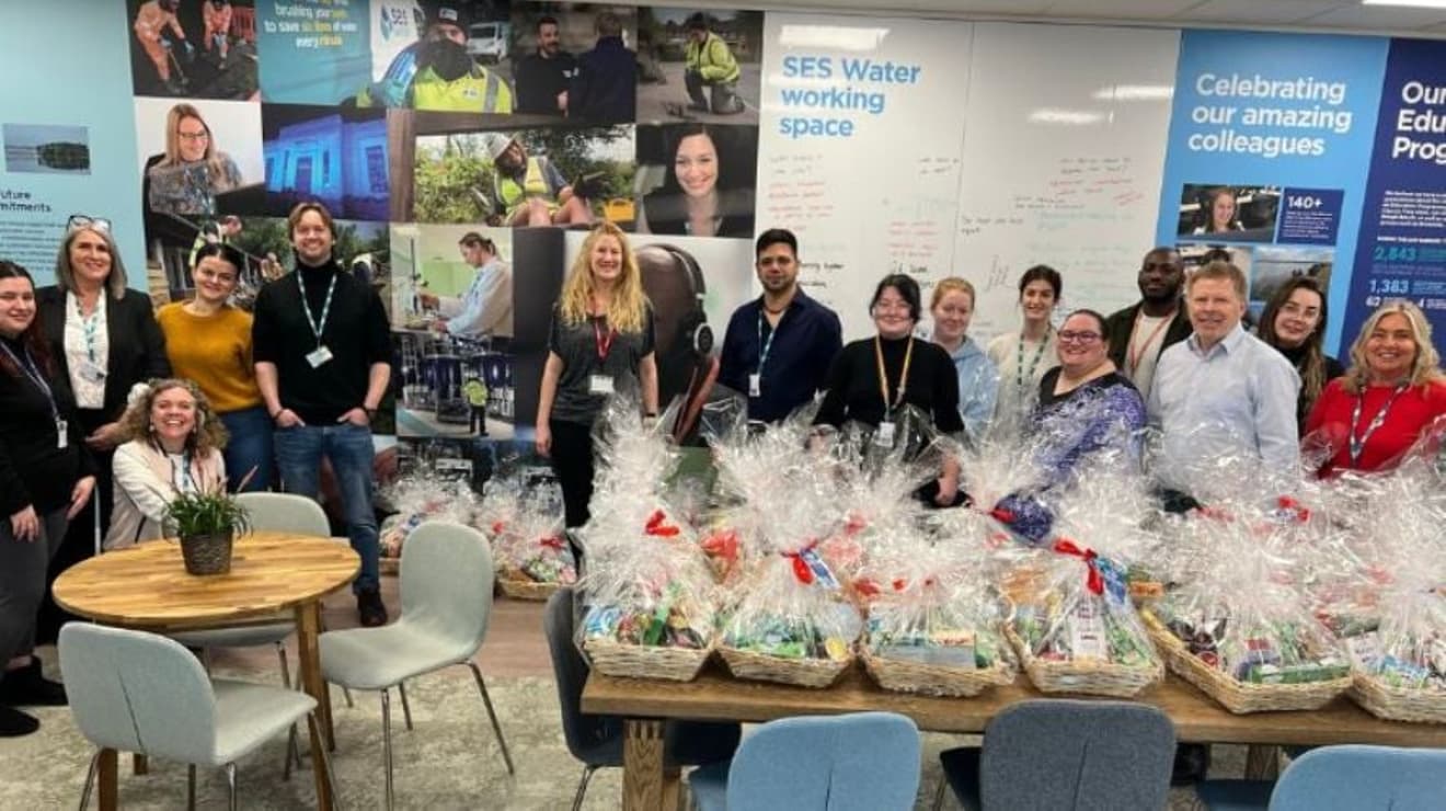 SES staff members with a table full of gift hampers
