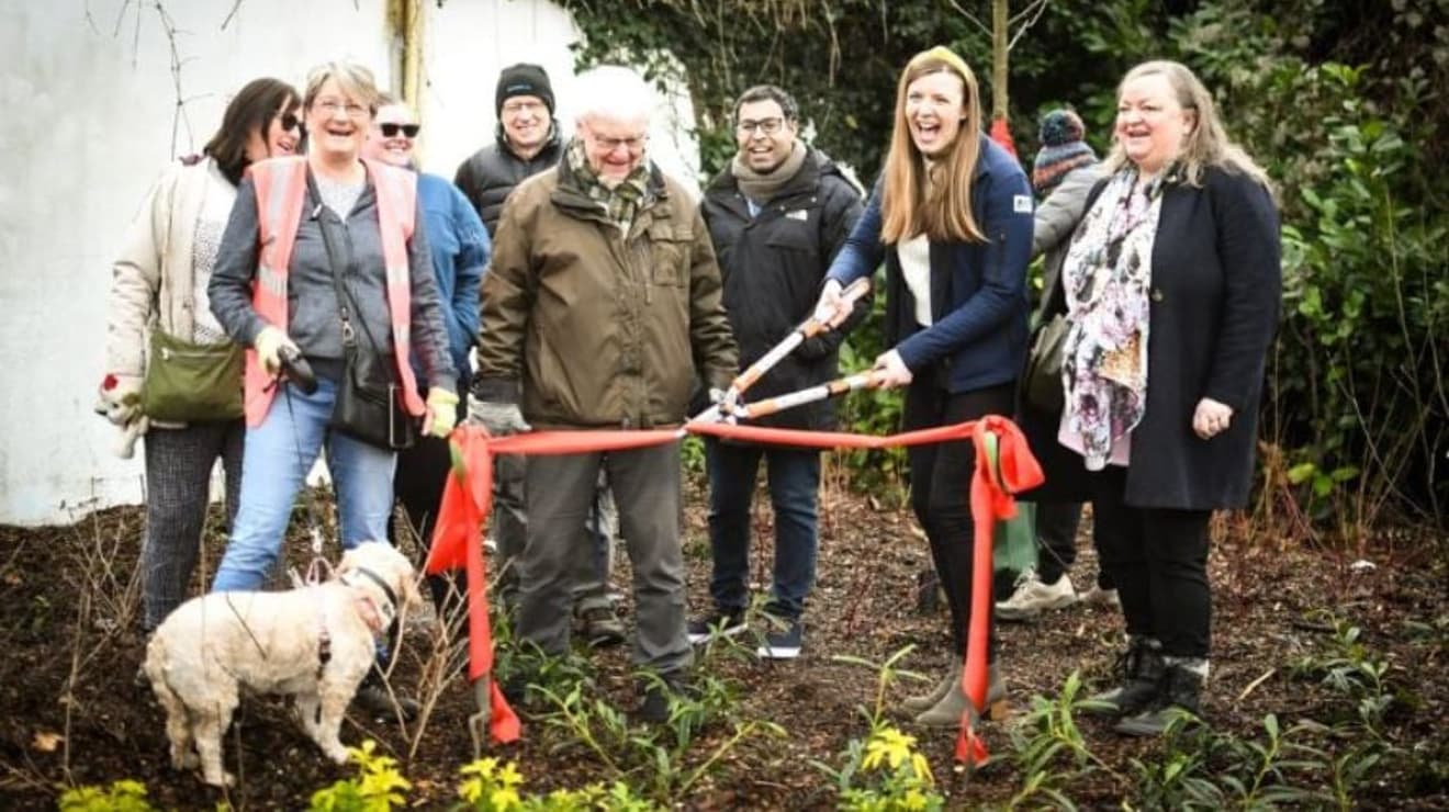 Community members cutting a red ribbon