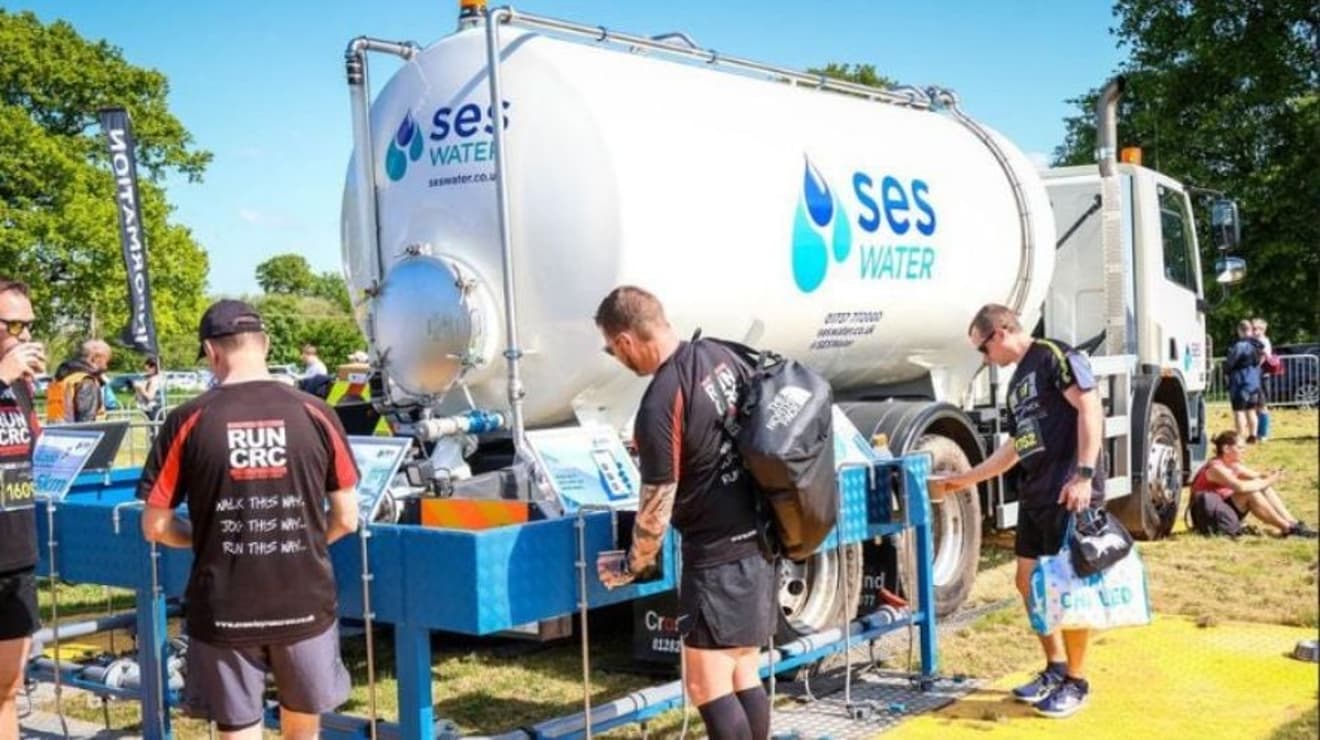 SES Water tanker with a man filling up a water bottle