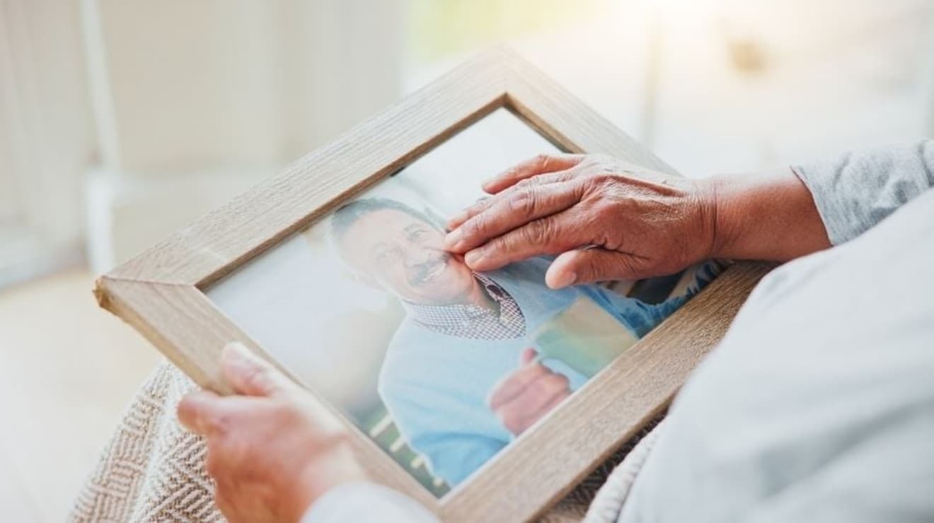 person holding a photograph of a loved one