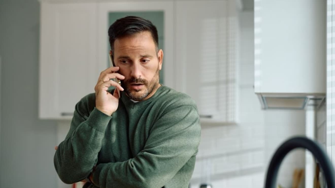 Man on the phone in the kitchen