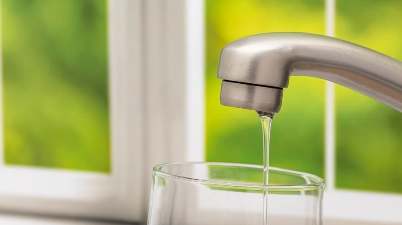 Water running from a kitchen tap slowly due to low water pressure
