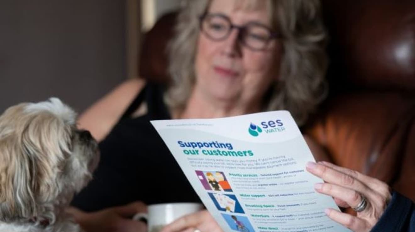 Lady reading a document with her dog