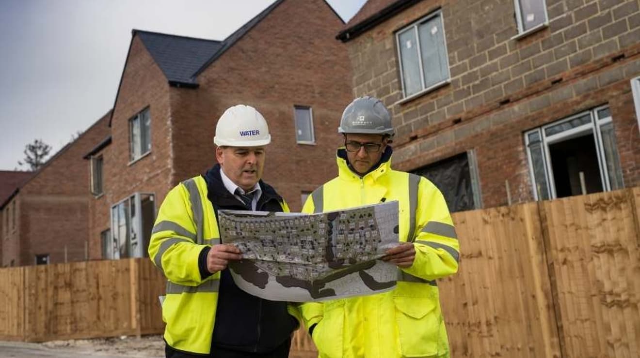 SES water engineer with home developer looking at plans