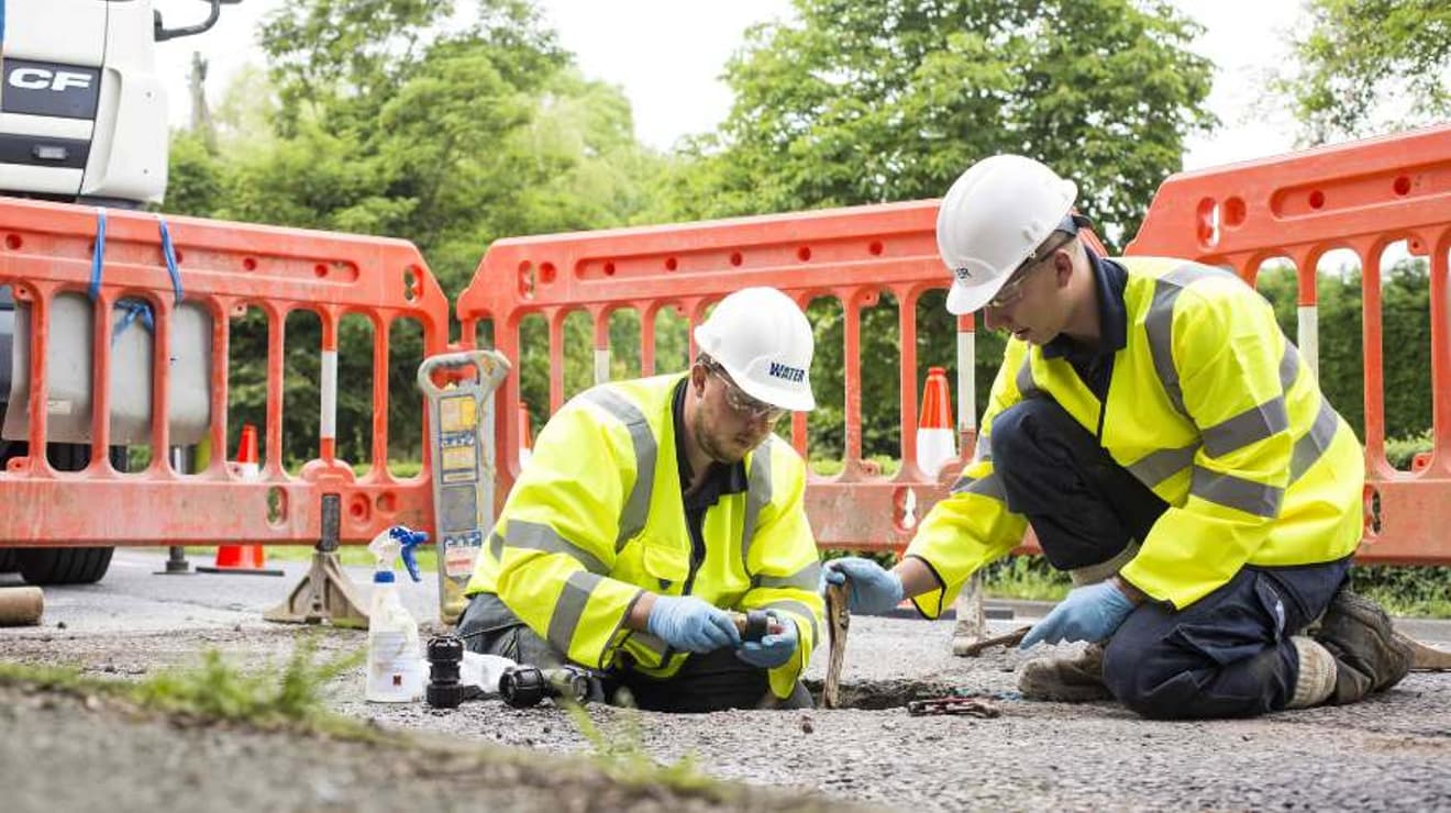 SES engineers working in a hole in the ground fixing a leak