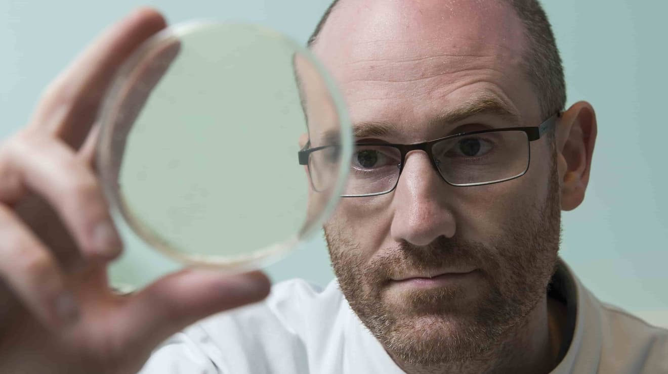 Man holding up a sample dish