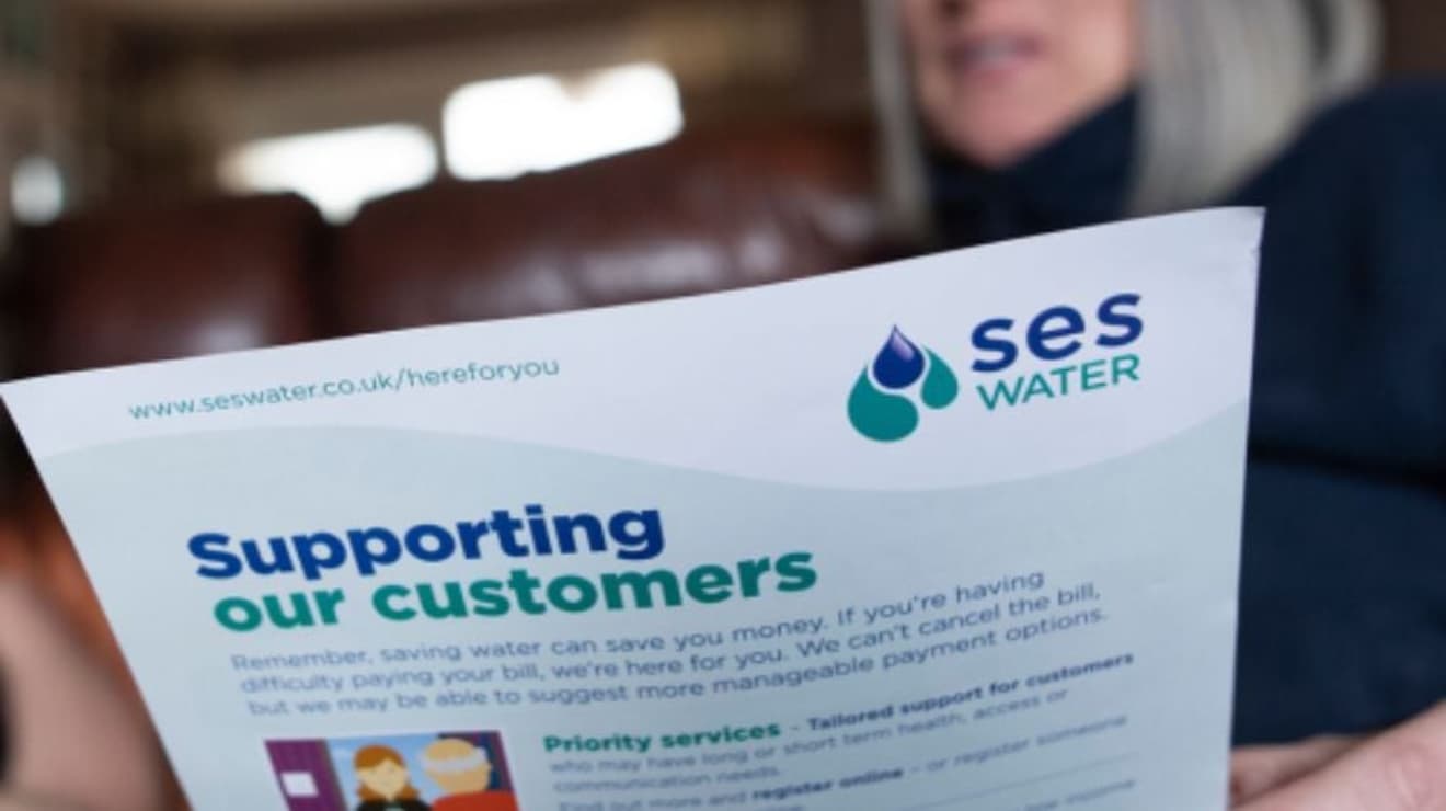 Supporting our customers A4 document held in a persons hand