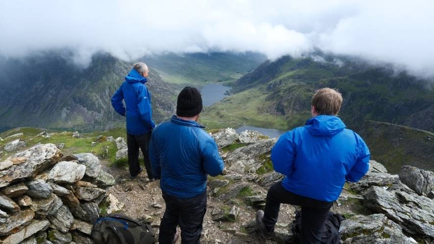 SES Water hikers at the summit looking down the mountain range